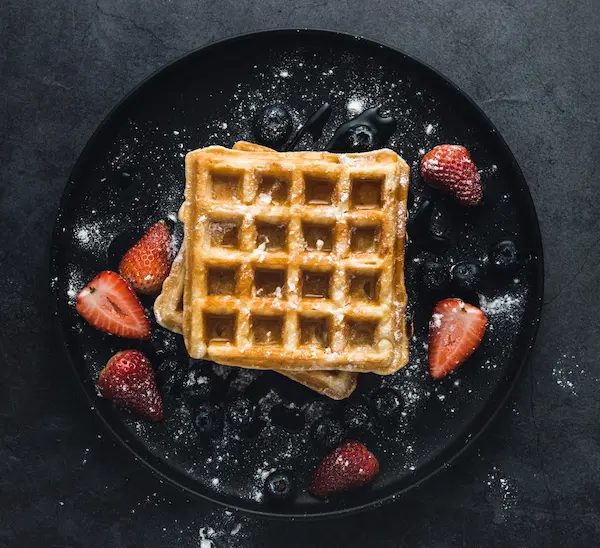Munch Station build-your-own dessert base: A golden-brown Belgian-style waffle, crispy on the outside and soft on the inside, ready for toppings.
